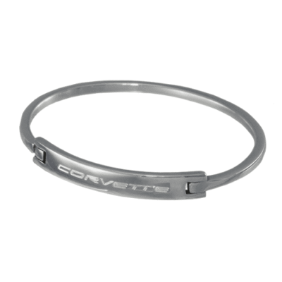 A sleek silver bracelet featuring an engraved "Corvette" logo on a polished central plate. The minimalist design conveys elegance and automotive passion.