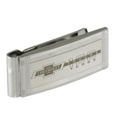 Silver money clip with engraved Chevrolet logo and "100 years" text, set against a black background. The clip conveys a sleek, classic design.