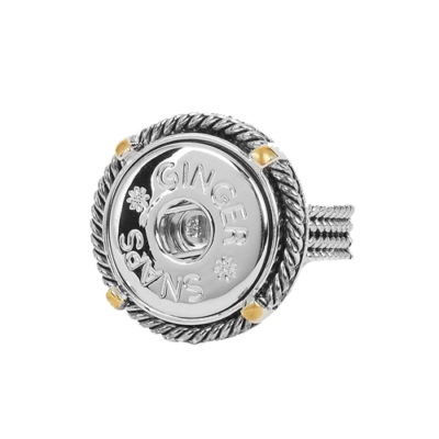 A metallic ring with a circular, rope-like design and yellow accents. The center features the text "Ginger Snaps" with small flower motifs, conveying elegance.