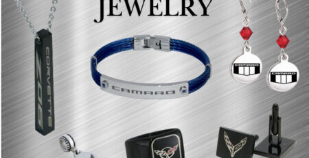 Assorted stainless steel jewelry featuring Corvette and Camaro themes. Includes a pendant, bracelet, ring, earrings, and cufflinks on a brushed metal background.